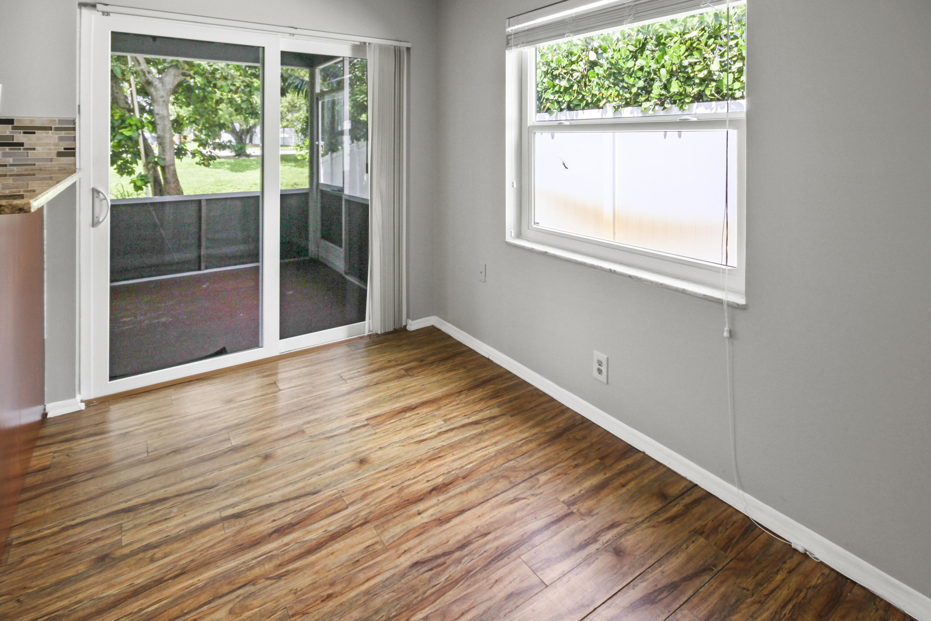 22493 Southwest 56th Avenue Boca Raton, FL 33433 - Photo 22 of 31 a view of an empty room with wooden floor and a window