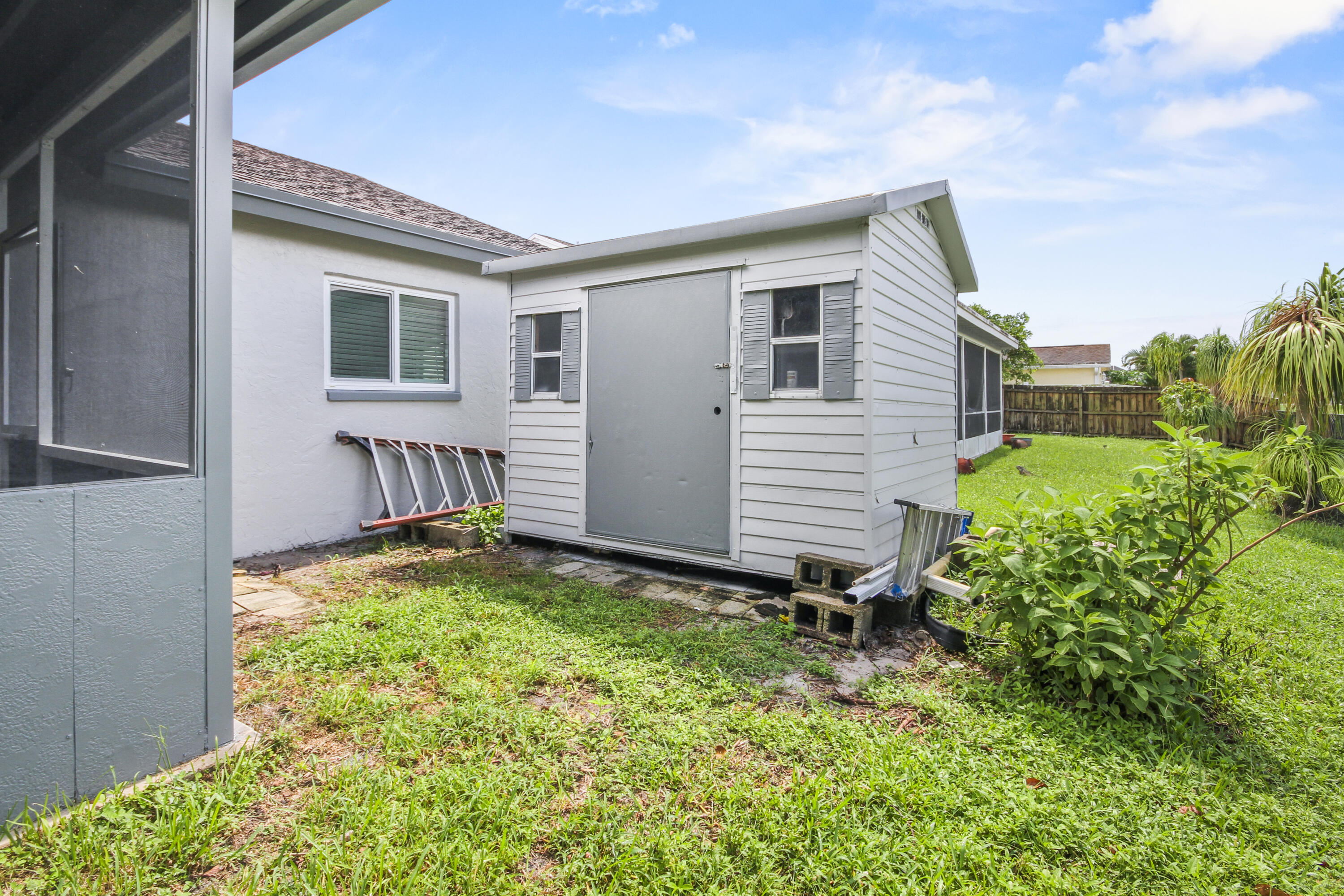 22493 Southwest 56th Avenue Boca Raton, FL 33433 - Photo 28 of 31 a backyard of a house with a table and chairs