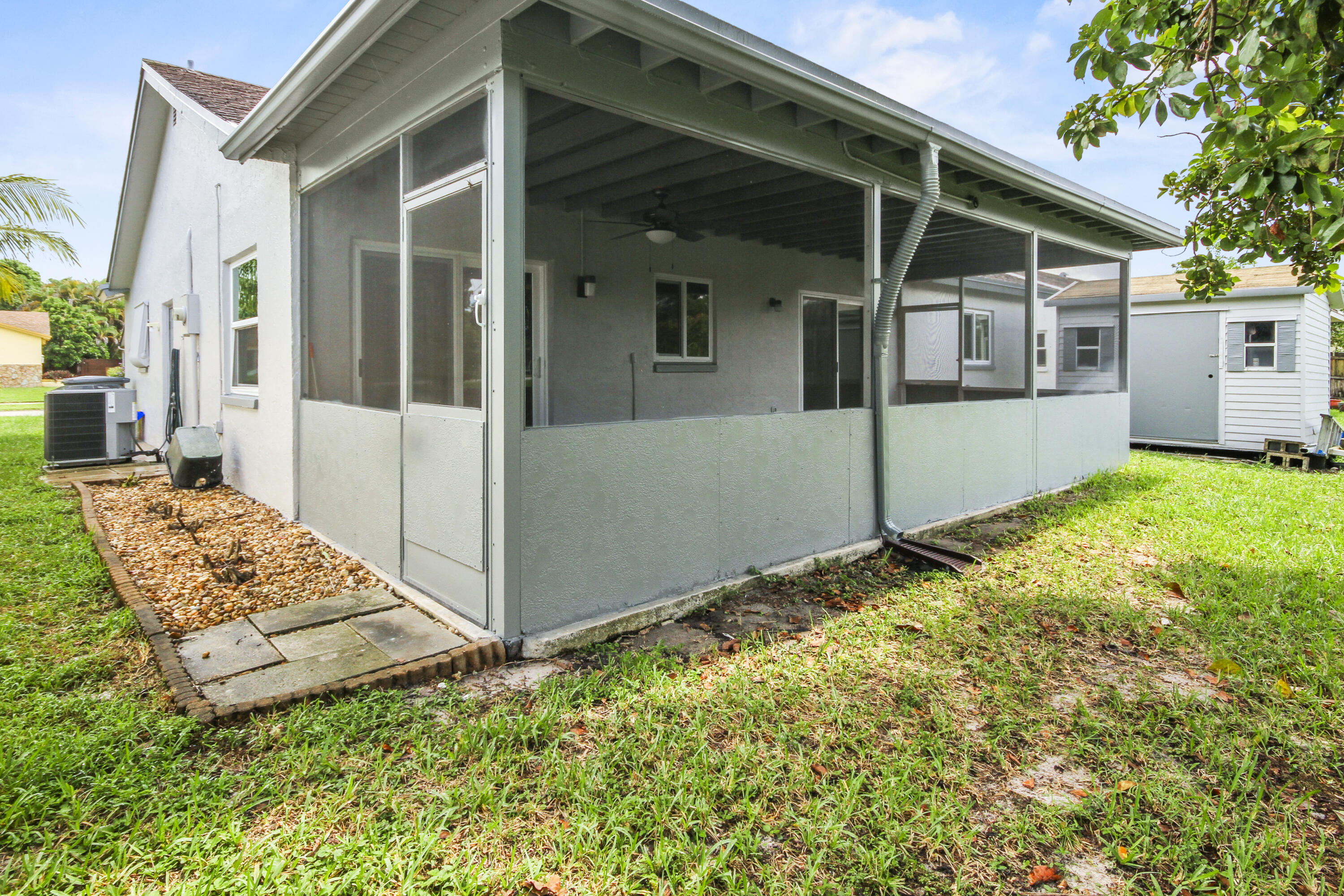 22493 Southwest 56th Avenue Boca Raton, FL 33433 - Photo 30 of 31 front view of a house with a yard