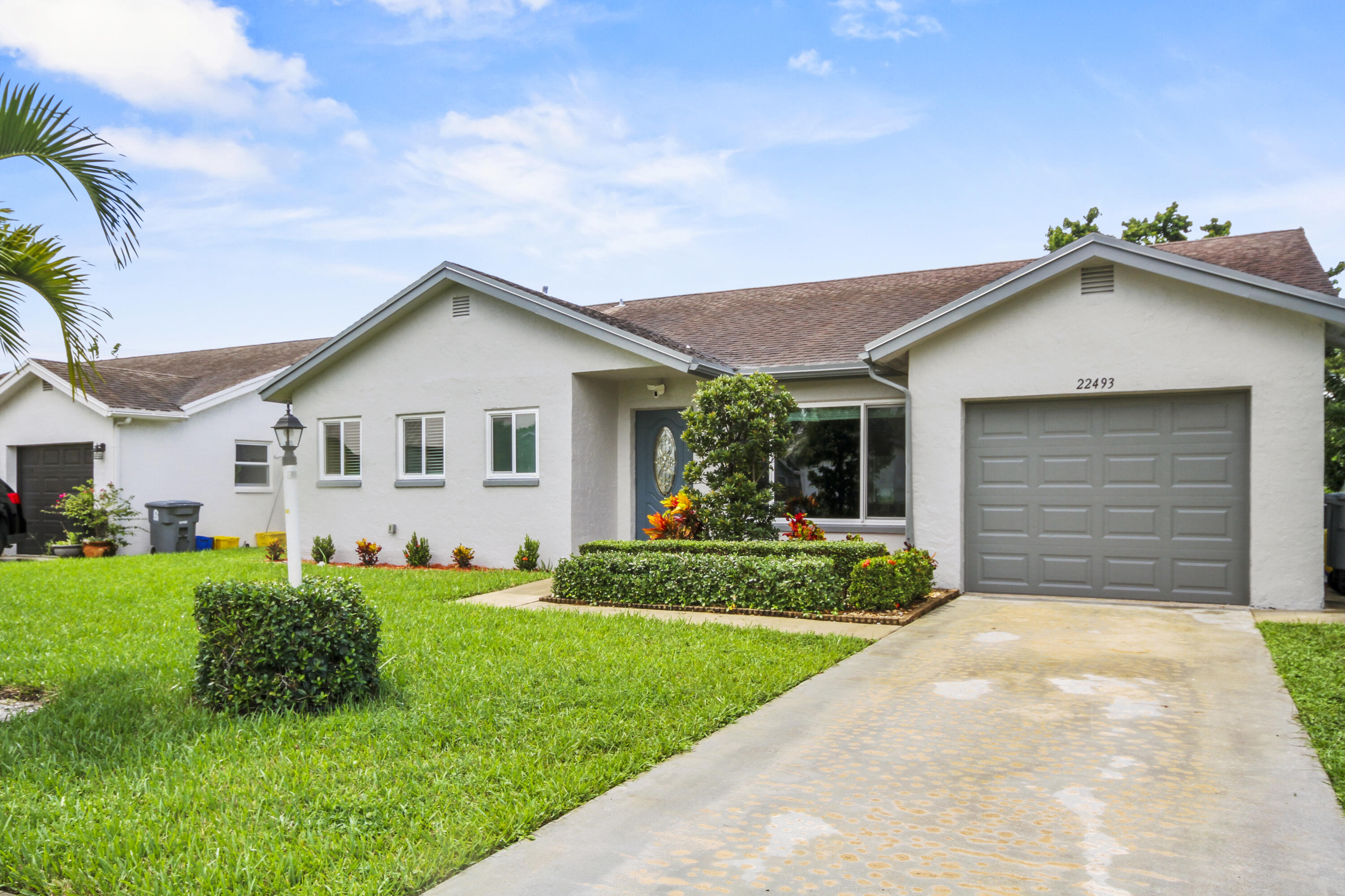 22493 Southwest 56th Avenue Boca Raton, FL 33433 - Photo 31 of 31 a front view of a house with a yard