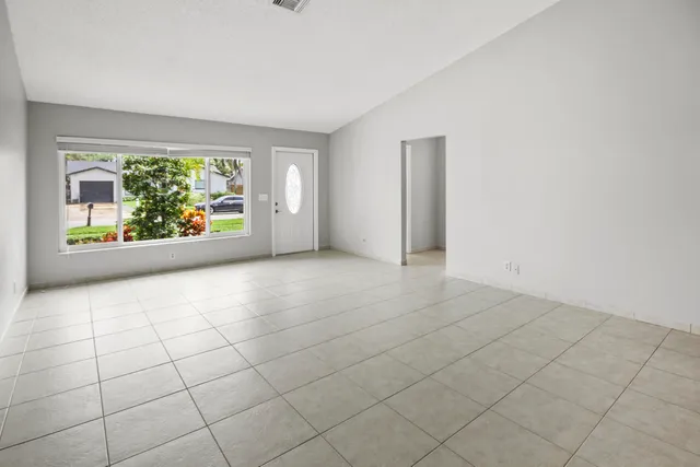 an empty room with windows and mountain view