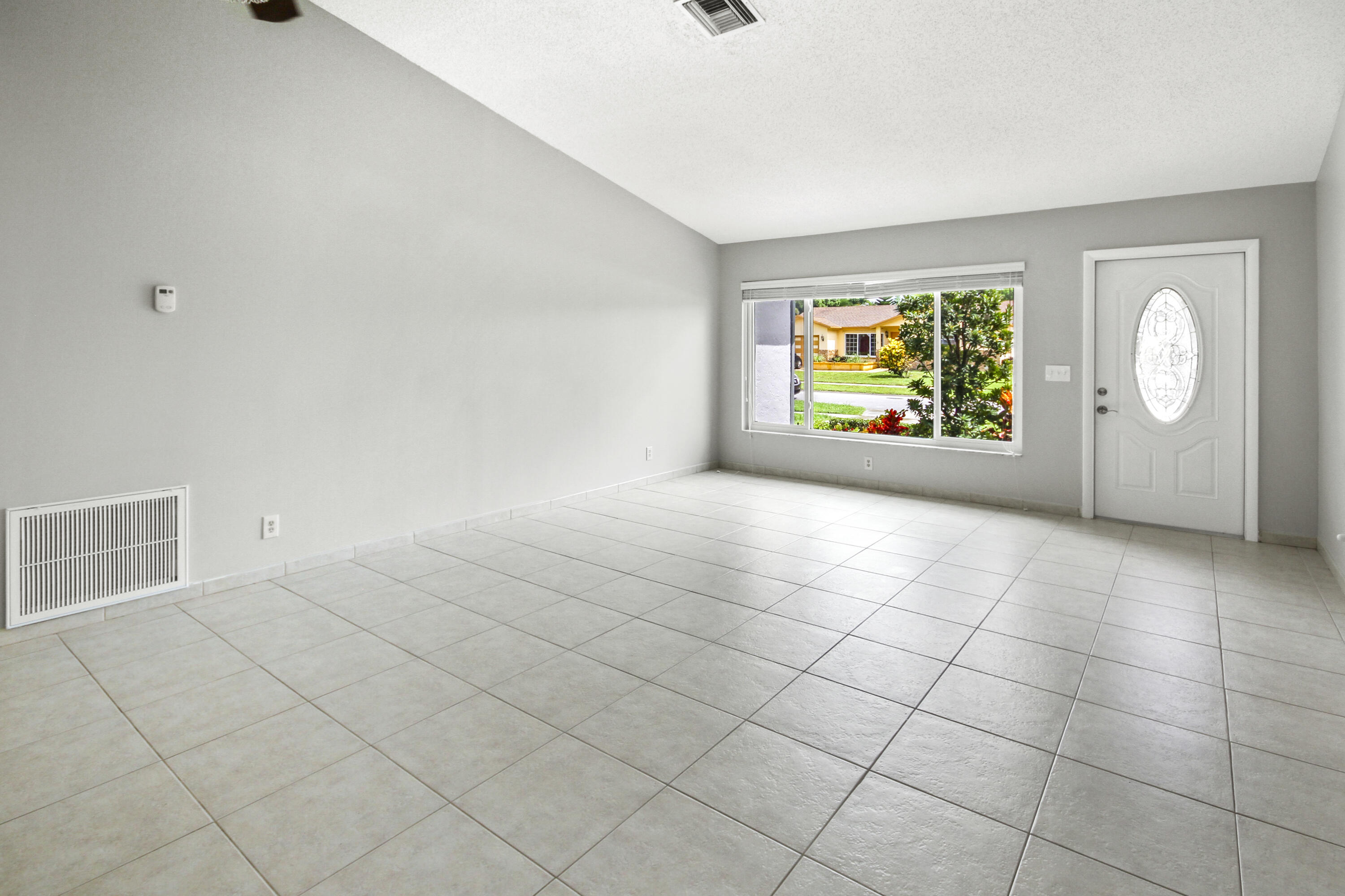 22493 Southwest 56th Avenue Boca Raton, FL 33433 - Photo 5 of 31 a view of an empty room with a window