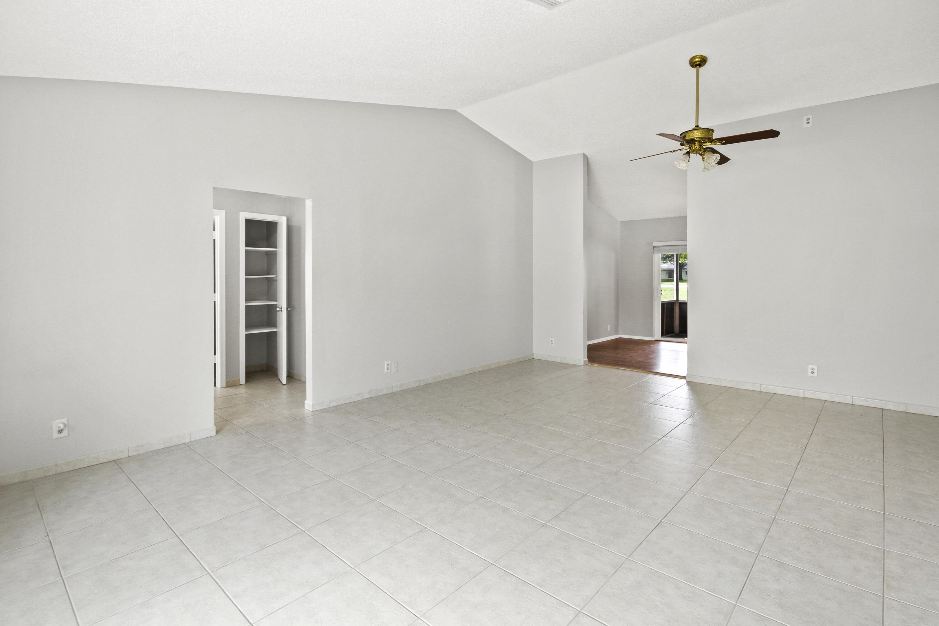 22493 Southwest 56th Avenue Boca Raton, FL 33433 - Photo 7 of 31 an empty room with windows and fan