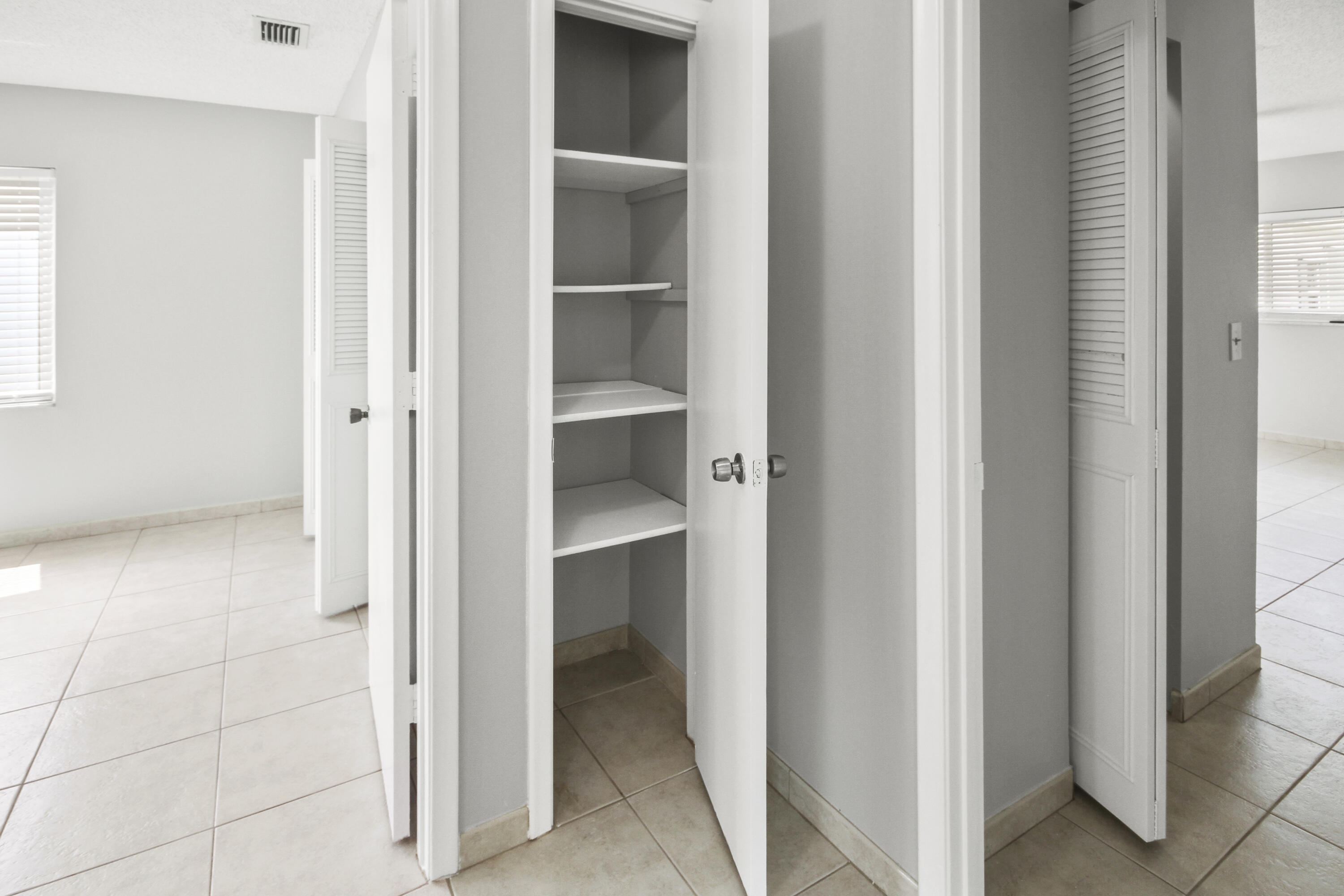 22493 Southwest 56th Avenue Boca Raton, FL 33433 - Photo 8 of 31 a view of a hallway with closet and a window