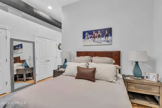 a bedroom with bed and painting on the wall