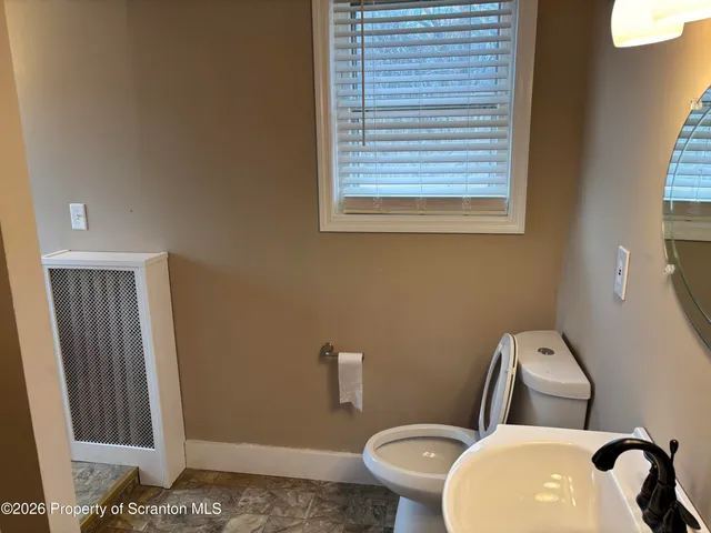 a white toilet sitting next to a bathroom sink