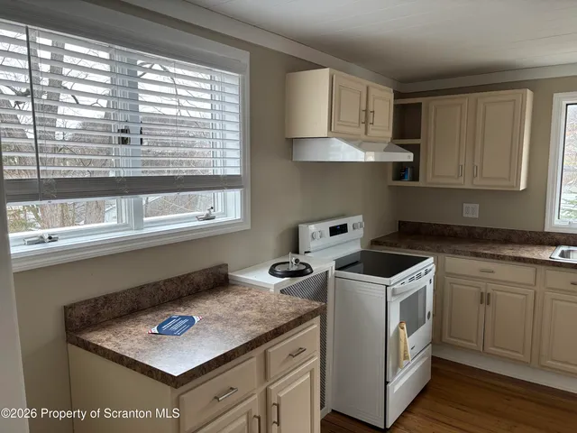 a kitchen with appliances cabinets and a sink