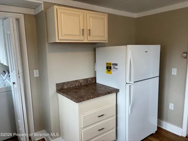 a white refrigerator freezer sitting inside of a kitchen