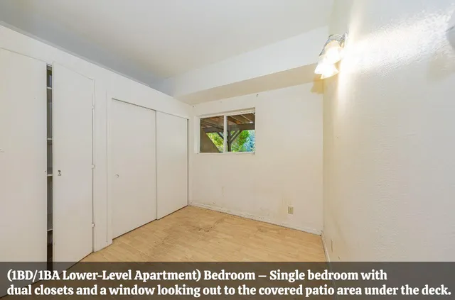 a view of bathroom with a window mirror and toilet