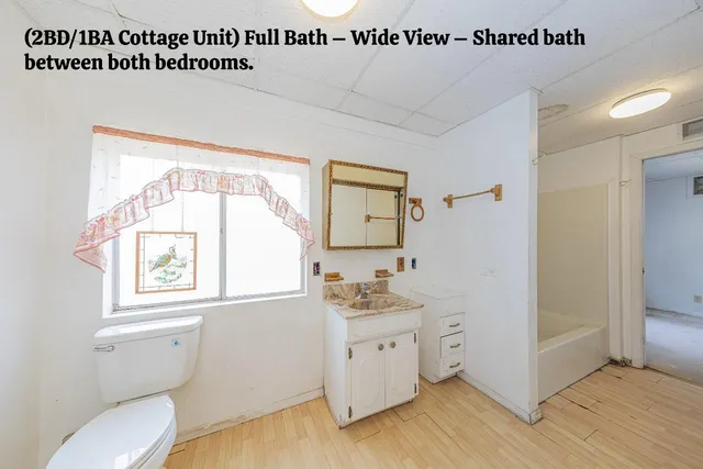 a view of a room with window and ceiling fan