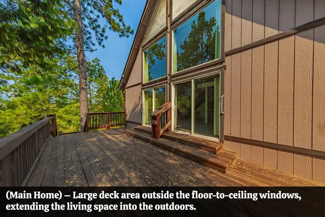 a view of a balcony with wooden floor and fence