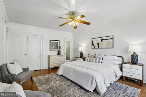 a bedroom with a bed couches and window