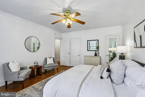 a bedroom with a large bed and a chandelier
