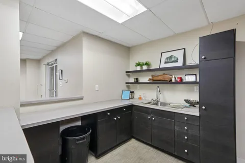 a kitchen with a sink dishwasher and cabinets