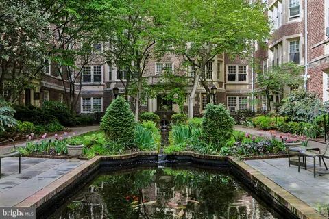 a swimming pool with outdoor seating and plants