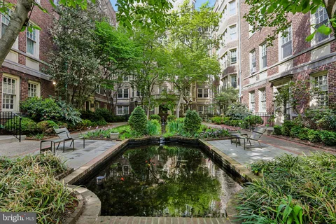 a swimming pool with outdoor seating and yard