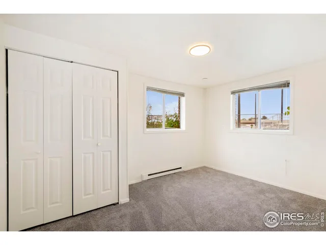 a view of an empty room with closet