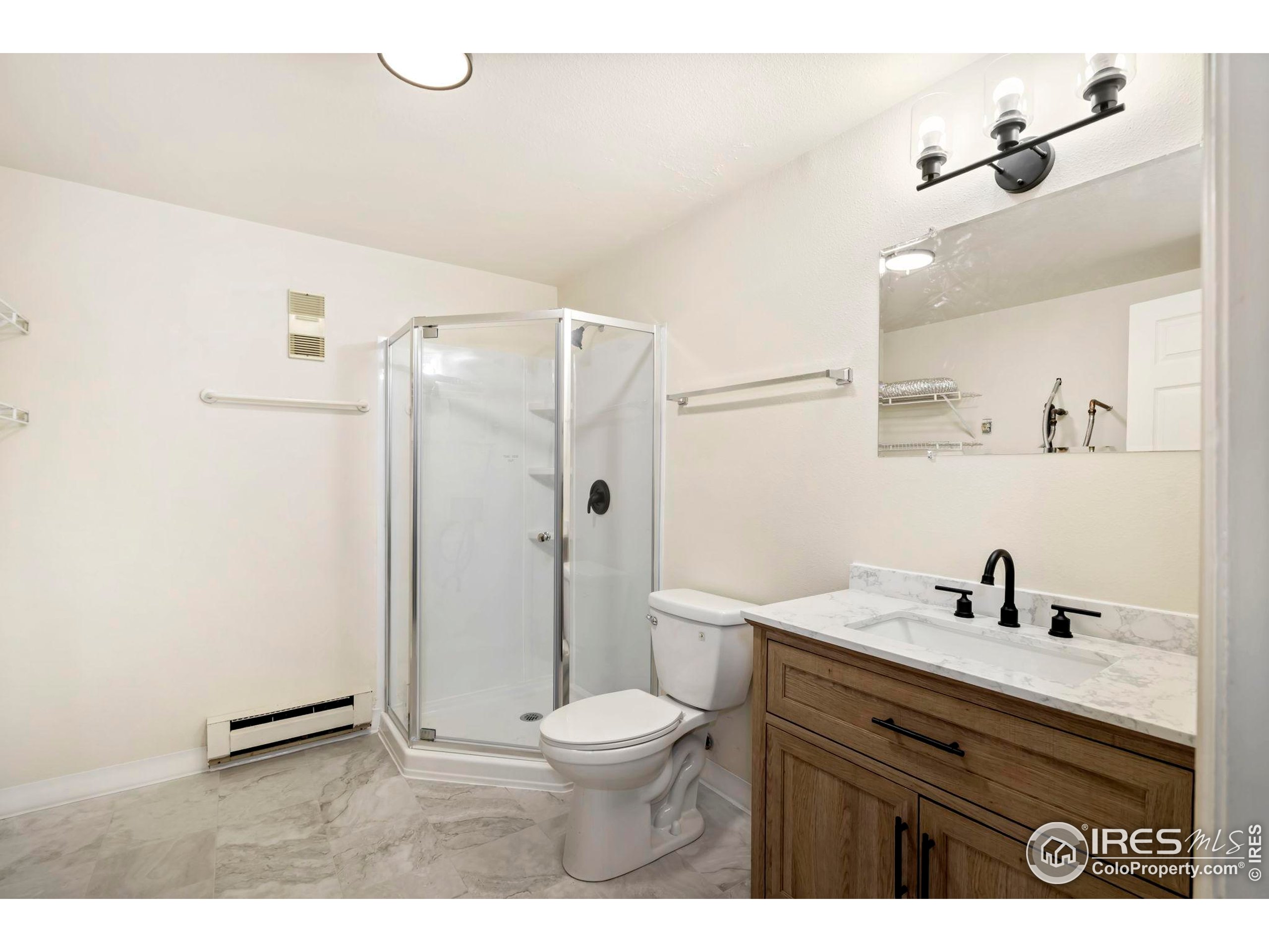 2828 Silverplume Drive, Unit R3 Fort Collins, CO 80526 - Photo 26 of 44 a bathroom with a sink a toilet a mirror and shower