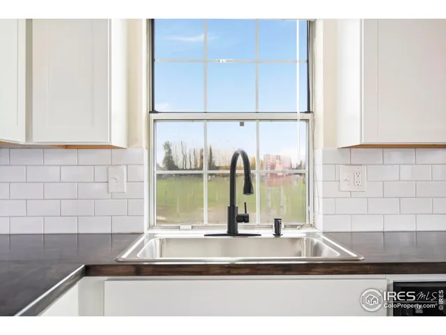 a view of a kitchen with a sink and a window