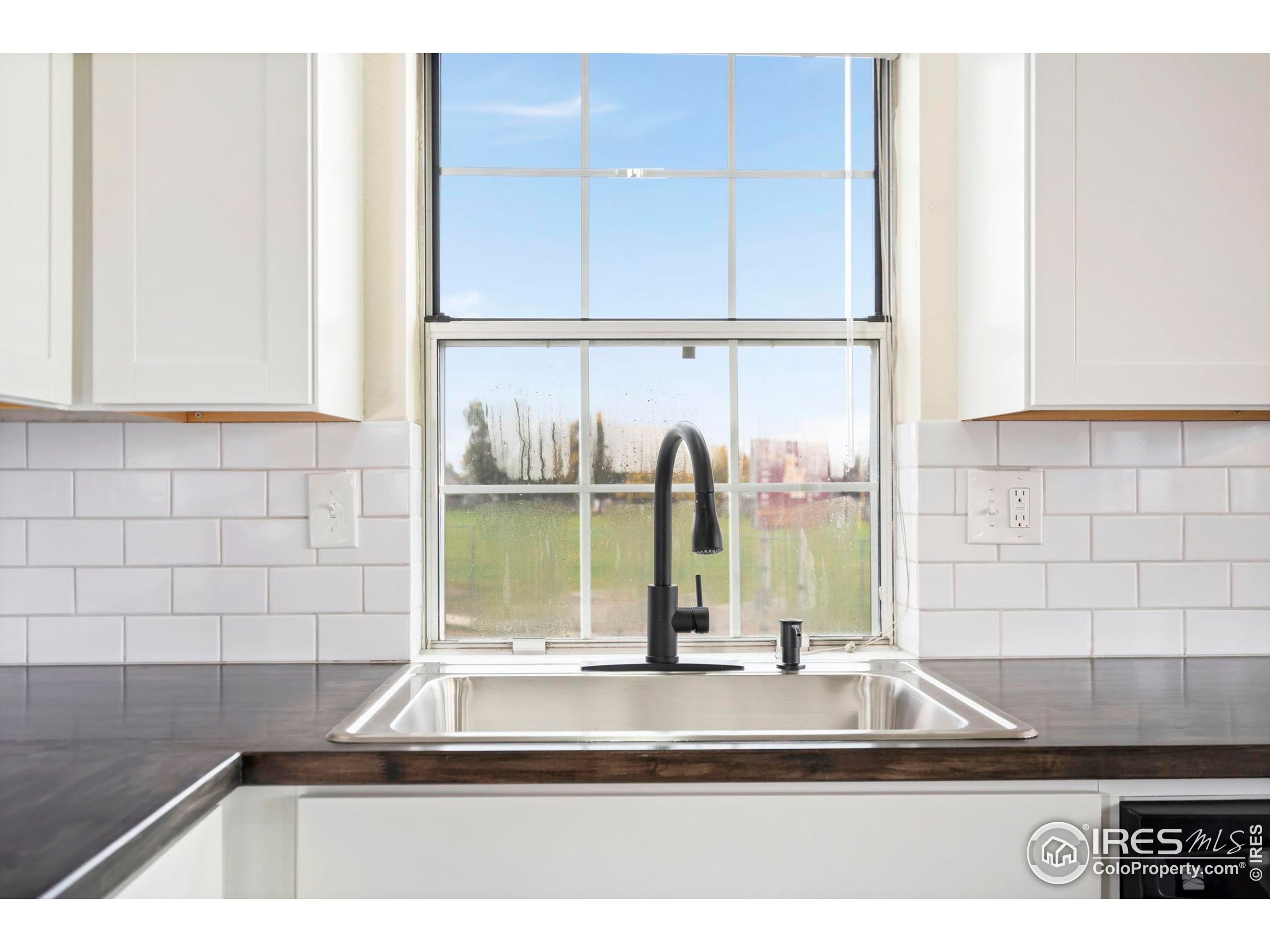 2828 Silverplume Drive, Unit R3 Fort Collins, CO 80526 - Photo 9 of 44 a view of a kitchen with a sink and a window