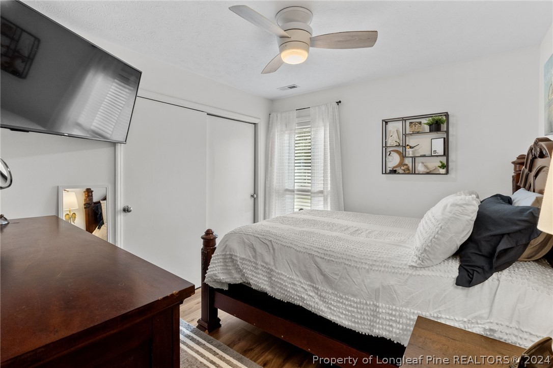 5334 Tory Hill Road Hope Mills, NC 28348 - Photo 11 of 27 a bedroom with a bed and a chandelier