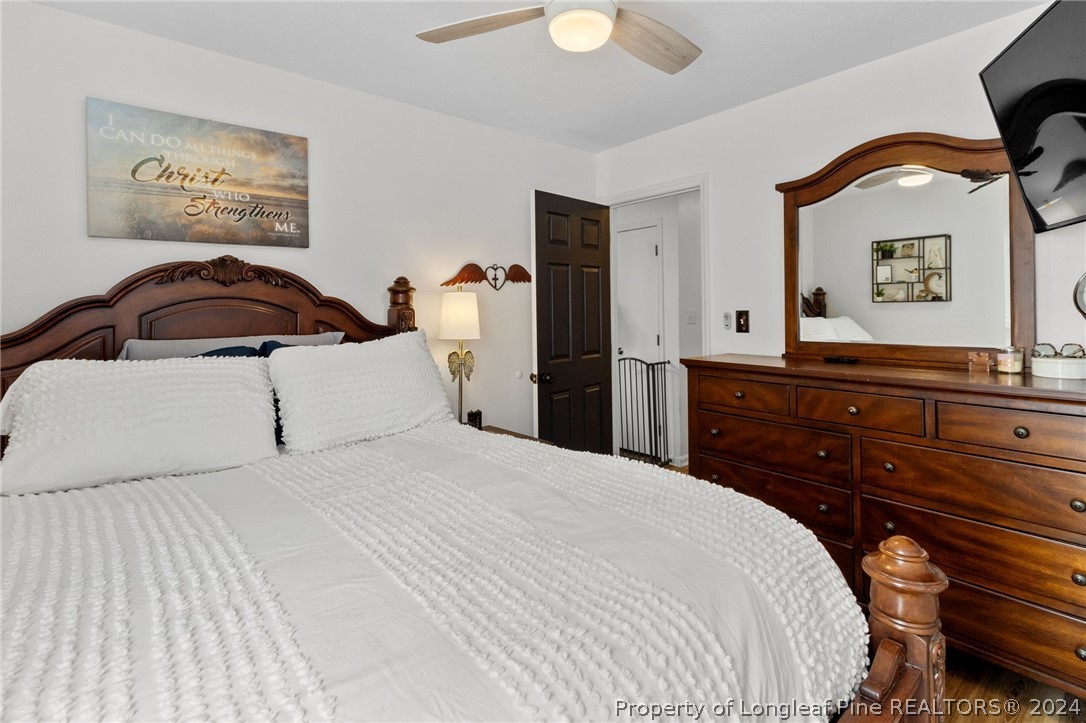 5334 Tory Hill Road Hope Mills, NC 28348 - Photo 12 of 27 a bedroom with a bed and a painting on the wall