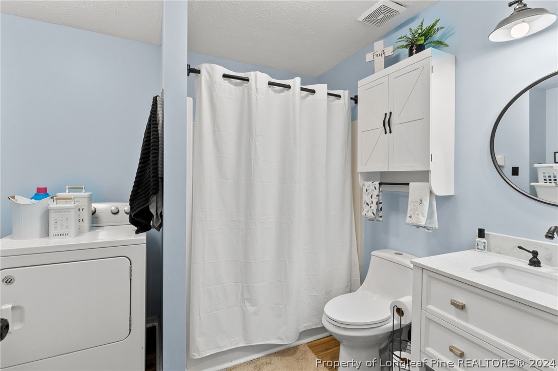 5334 Tory Hill Road Hope Mills, NC 28348 - Photo 13 of 27 a bathroom with a sink toilet and a mirror