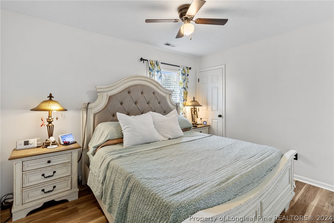 5334 Tory Hill Road Hope Mills, NC 28348 - Photo 16 of 27 a bedroom with a bed and a chandelier