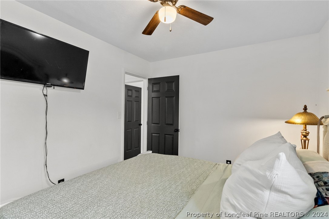 5334 Tory Hill Road Hope Mills, NC 28348 - Photo 17 of 27 a bedroom with a bed and a flat screen tv