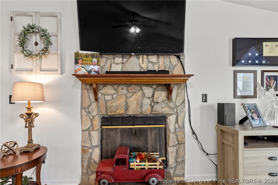 5334 Tory Hill Road Hope Mills, NC 28348 - Photo 4 of 27 a living room with furniture a flat screen tv and a fireplace