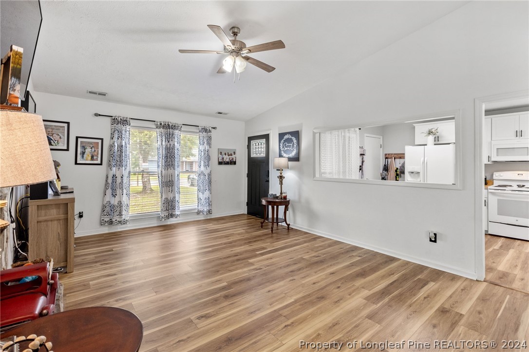 5334 Tory Hill Road Hope Mills, NC 28348 - Photo 5 of 27 a view of a livingroom with wooden floor and a ceiling fan