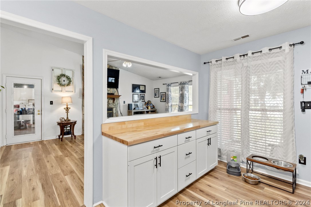 5334 Tory Hill Road Hope Mills, NC 28348 - Photo 8 of 27 a spacious bathroom with a granite countertop sink a mirror and a bathtub