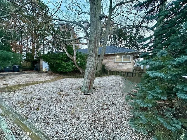 a front view of a house with a trees