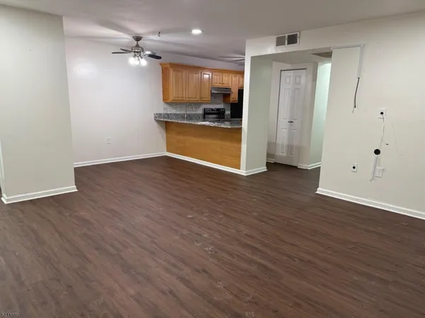 a view of a kitchen with a sink and a refrigerator