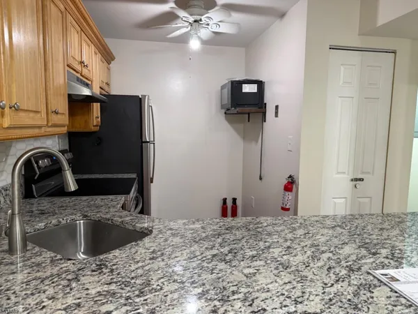 a kitchen with a sink cabinets and stainless steel appliances