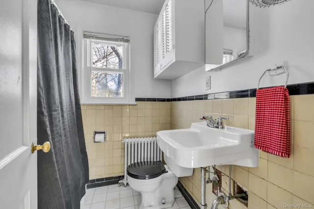 a bathroom with a sink toilet and mirror