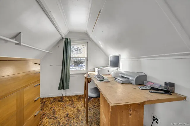 a room with a table chairs and a refrigerator