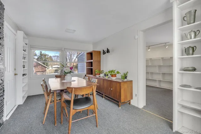 a dining room with furniture and window