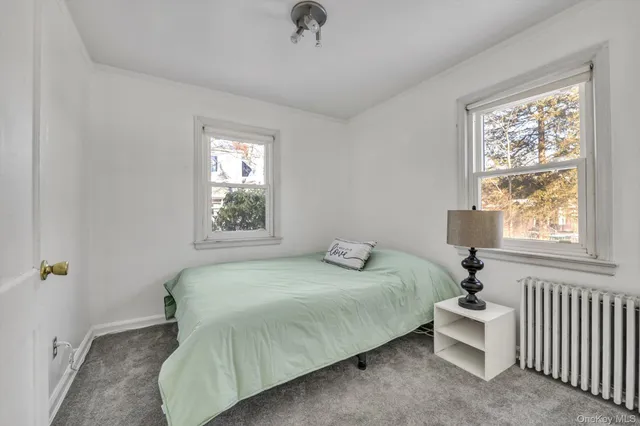 a bedroom with a bed and window