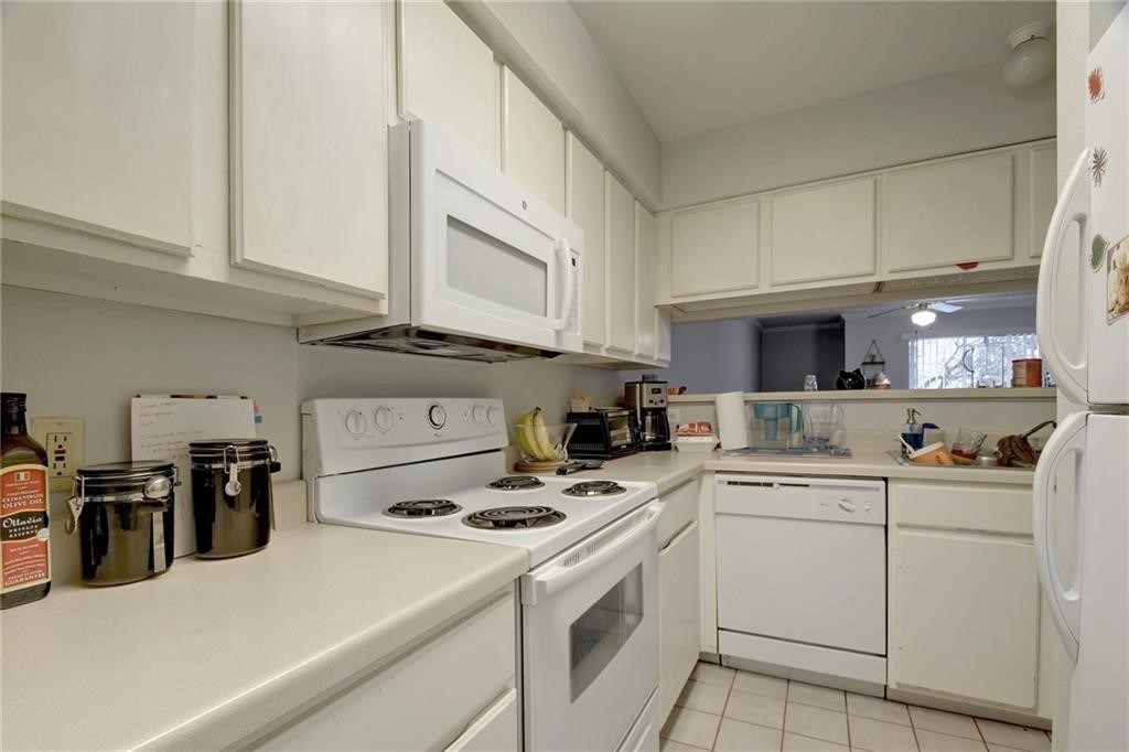 501 West 26th Street, Unit 121 Austin, TX 78705 - Photo 4 of 12 a kitchen with appliances cabinets and a sink