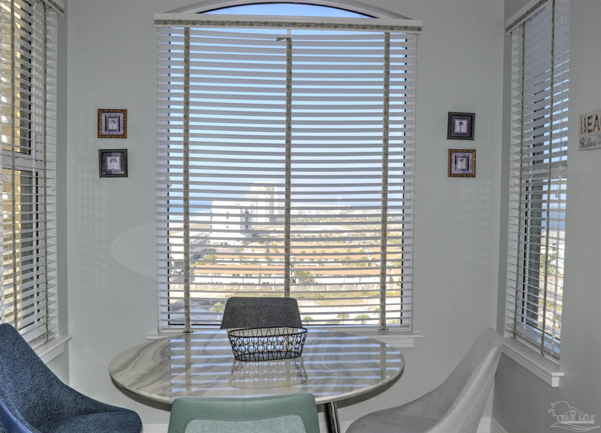 8501 Gulf Boulevard, Unit 10F Navarre, FL 32566 - Photo 15 of 35 a view of a room that has a table and a chair
