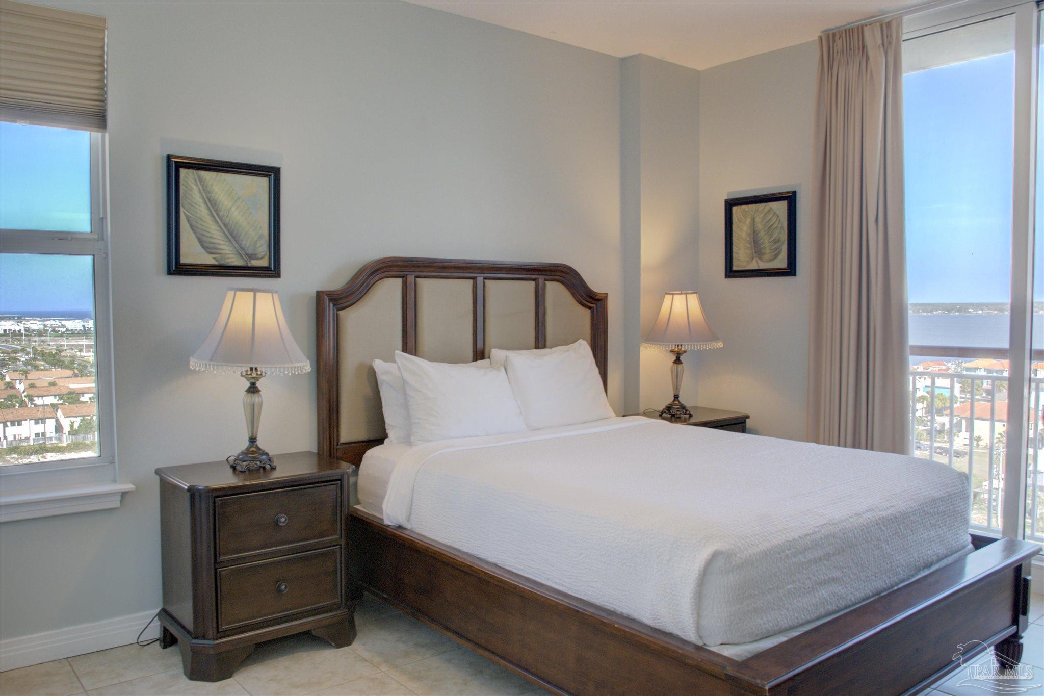 8501 Gulf Boulevard, Unit 10F Navarre, FL 32566 - Photo 24 of 35 a bedroom with a bed and a window