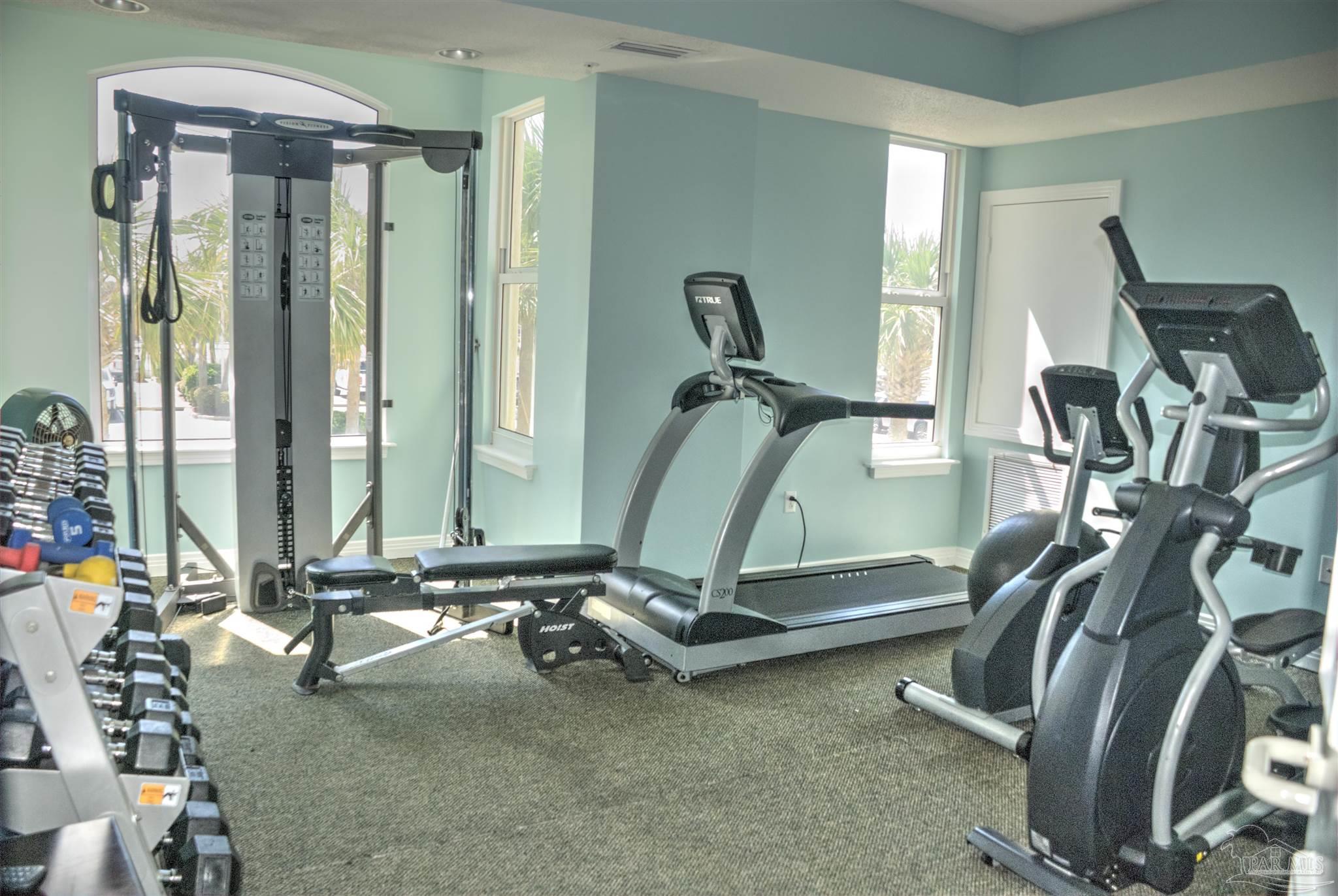 8501 Gulf Boulevard, Unit 10F Navarre, FL 32566 - Photo 32 of 35 a room with gym equipment and large mirror