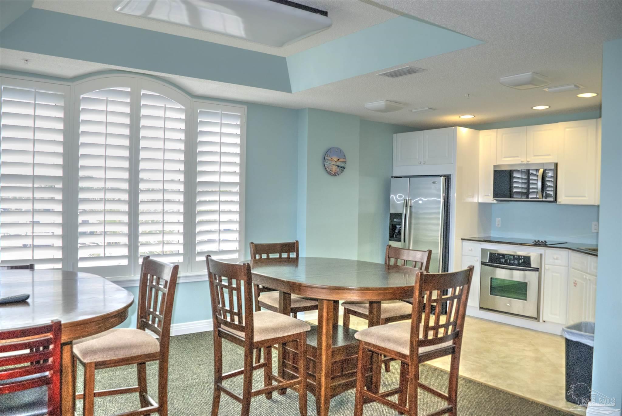 8501 Gulf Boulevard, Unit 10F Navarre, FL 32566 - Photo 34 of 35 a view of a dining room with furniture and window
