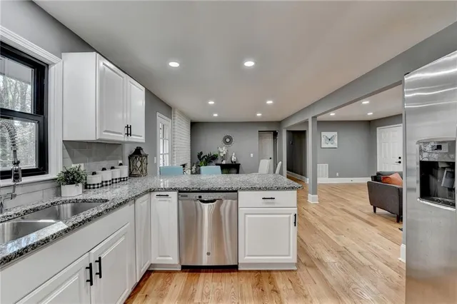 a view of a livingroom with wooden floor and furniture