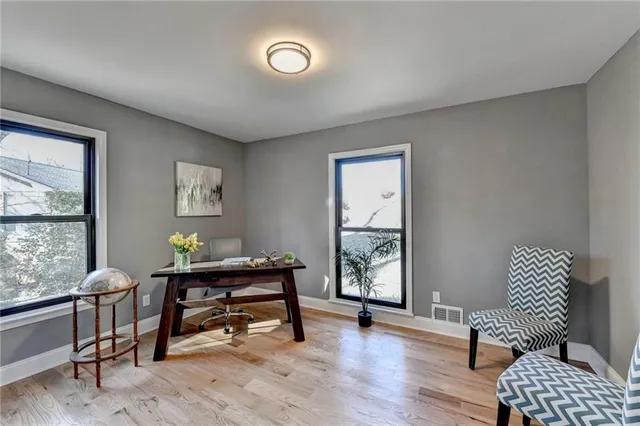 a kitchen with stainless steel appliances white cabinets and stove top oven