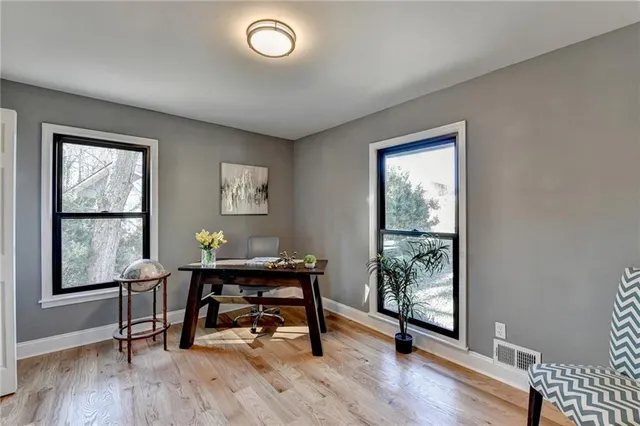 a view of a hallway with wooden floor and staircase