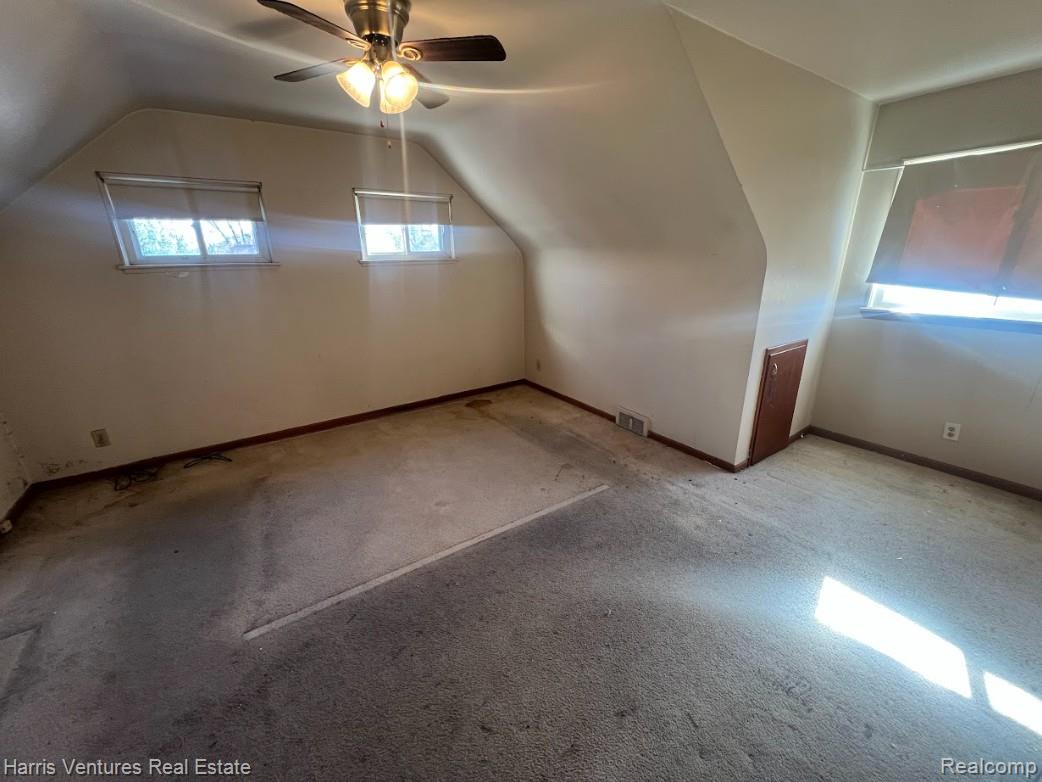 21111-15 Moross Road Grosse Pointe, MI 48236 - Photo 11 of 25 Bedroom with vaulted ceiling, carpet, and a ceiling fan (upper)