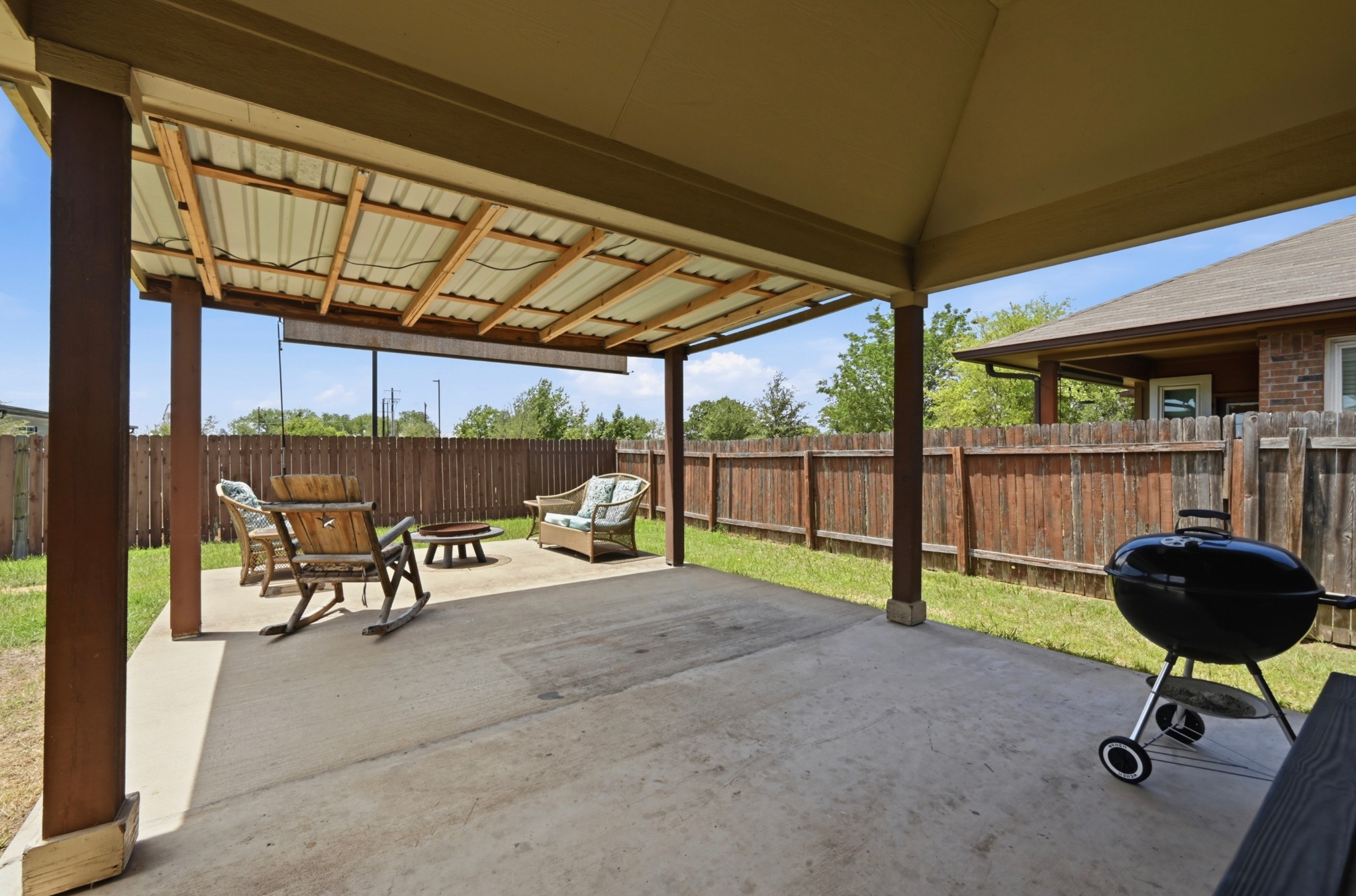 877 Hot Spring Valley Buda, TX 78610 - Photo 23 of 36 a view of a chairs and table in patio with a yard