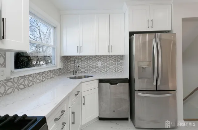 a kitchen with a refrigerator sink and cabinets